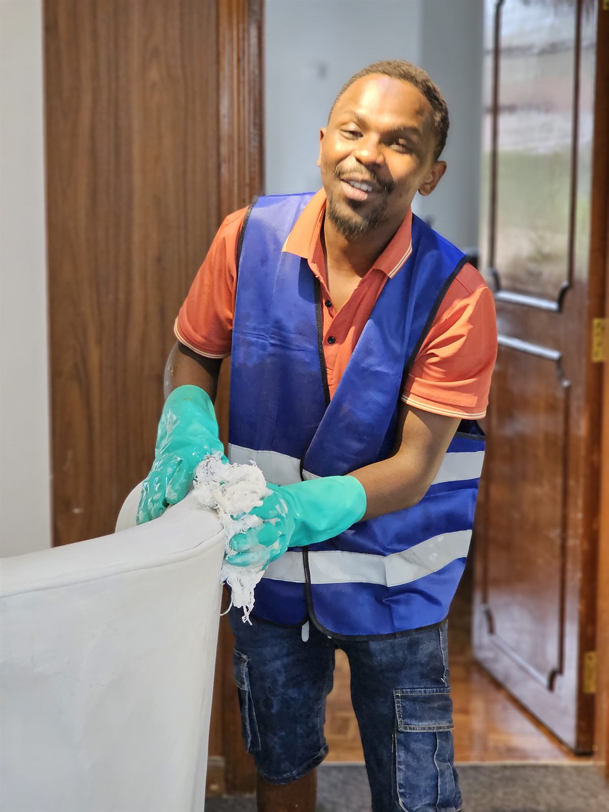 An OnyxHawk crew member deep-cleaning an upholstered armchair